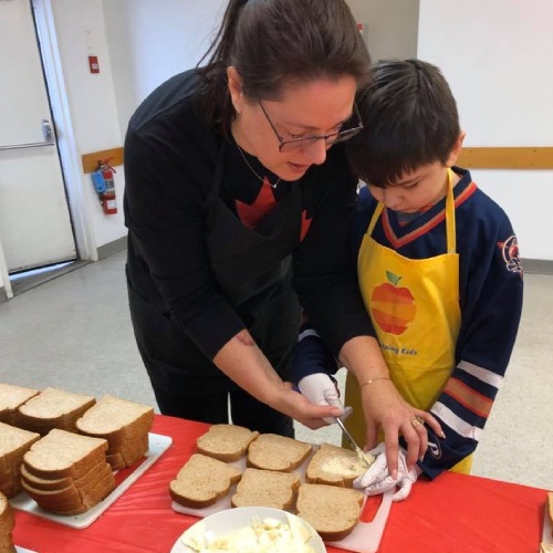 Adult assisting student volunteer